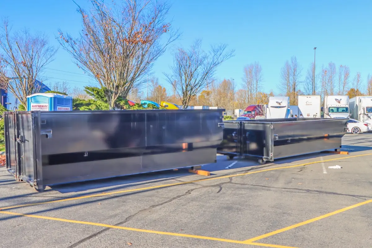 Professional dumpster rental service with roll-off container on residential driveway in Rancho Cordova
